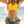 Vrouw in gele bikini top en blauwe bloemenprint slip op strand, zomermode, strandkleding, trendy badmode, zonnige dag aan zee.