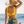 Vrouw in gele bikini en strohoed bij zee, met citrusprint op bikinibroekje. Zomerstrandmode, strandvakantie, zonnige dag.