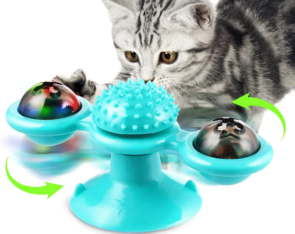 Turquoise kattenspeeltje met draaiende bollen en zuignap, ontworpen voor interactief spel en mentale stimulatie van katten. Perfect voor kattenliefhebbers.