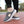 Grijze sportieve instapschoenen met ademend mesh bovenwerk en witte zool, ideaal voor wandelen en casual gebruik. Comfortabele en modieuze sneakers.