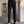 Man in gestreept overhemd en zwarte pantalon met hoge taille, bruine loafers. Stijlvolle herenmode, zakelijke outfit, moderne kledingstijl.