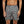 Grijze zwembroek met rode watermeloenprint, gedragen door een man. Trendy zwemkleding voor heren, ideaal voor strand en zwembad.