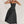 Elegante zwarte midi-jurk met spaghettibandjes, strapless ontwerp en volle rok. Perfect voor avondkleding en formele gelegenheden.