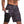 Man in camouflage sportshorts met smartphonezak, fitnesskleding, grijs en zwart patroon, ideaal voor hardlopen en training, comfortabele pasvorm.