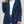 Vrouw in blauwe teddyjas, witte trui en spijkerbroek. Stijlvolle wintermode, trendy dameskleding, casual outfit.