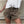 Vrouw draagt luipaardprint shorts en witte blouse, trendy zomeroutfit, modieuze dameskleding, casual stijl, stedelijke mode.