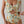Vrouw in bloemenbadpak met ruches en uitsnijding, zomermode, strandkleding, trendy damesbadmode, kleurrijk bloemenpatroon, elegante stijl.