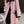 Roze damesjas met zwarte knopen en kraag, gedragen door model. Stijlvolle wintermode, elegante uitstraling, trendy dameskleding.