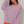 Vrouw in gestreepte trui met roze en blauwe strepen, oranje boorden, casual look, modieuze dameskleding, trendy outfit, witte achtergrond.