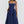 Vrouw in elegante blauwe midi-jurk met spaghettibandjes, perfecte zomeroutfit. Stijlvolle mode voor dames, casual en chic.