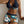 Vrouw in sportieve bikini met tropisch bladpatroon, haltertop en korte broek. Perfect voor strandmode en zomerse zwemkledingtrends.
