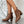 Bruine slangenleren enkellaarsjes met blokhak, gedragen door model. Trendy damesmode, perfect voor herfst- en winteroutfits. Stijlvolle schoenen.