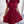 Vrouw in elegante bordeauxrode jurk met plooien en strik, staand in moderne kamer. Perfect voor mode, dameskleding, stijlvolle outfits.