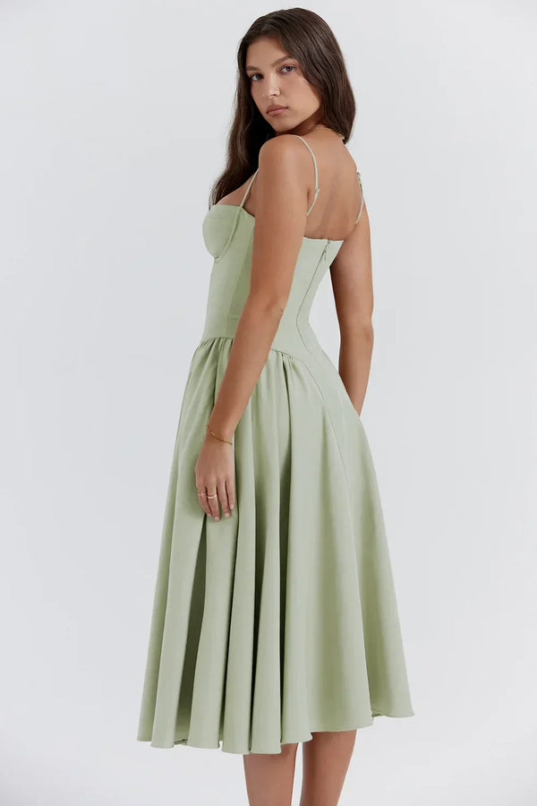 Vrouw in elegante, lichtgroene midi-jurk met spaghettibandjes, perfecte zomeroutfit. Stijlvolle mode, trendy dameskleding, casual chic.