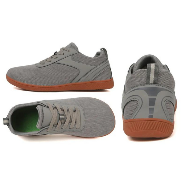Grijze sportschoenen met bruine zool, zij- en bovenaanzicht. Ademend mesh-materiaal, ideaal voor hardlopen en casual gebruik. Unisex design.
