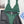 Groene ribgebreide bikini met triangel top en hoge taille slip, gestyled op zwarte leren rok en witte blouse. Perfecte strandkleding voor dames.