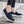 Zwarte dames sneakers met dikke witte zool, ademend mesh, slip-on design. Comfortabele schoenen voor dagelijks gebruik, wandelen, casual stijl.