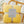 Gele fleece deken op rotan stoel, Home Collection label, zachte en warme textuur, perfect voor interieurdecoratie en comfort in de woonkamer.