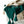 Groene gebreide deken met kwastjes op witte draadmand, naast beige deken en bril. Stijlvolle woondecoratie, gezellige textielaccessoires.
