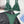 Groene ribgebreide bikini set met verstelbare bandjes en metalen sluiting, gestyled op een zwarte leren rok en witte blouse. Perfect voor zomertrends.