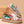 Floral damessneakers met kleurrijke bloemenprint, witte veters en rits, op houten achtergrond. Trendy casual schoenen voor lente en zomer.