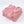 Gevouwen roze gebreide deken met kwastjes, zachte textuur, perfect voor interieurdecoratie en comfort. Ideaal voor slaapkamer of woonkamer styling.