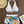 Dames bikini set met tropische print, haltertop en hoge taille shorts op houten achtergrond. Inclusief zonnebril en strohoed. Perfect voor strandmode.