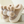 Beige pluche pantoffels met dikke zool en decoratieve pompons, ideaal voor wintercomfort. Warme dameshuisschoenen, stijlvol en knus.