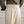 Beige wollen broek met hoge taille en plooien, gedragen met een olijfgroen overhemd. Stijlvolle herenmode, klassieke en elegante uitstraling.