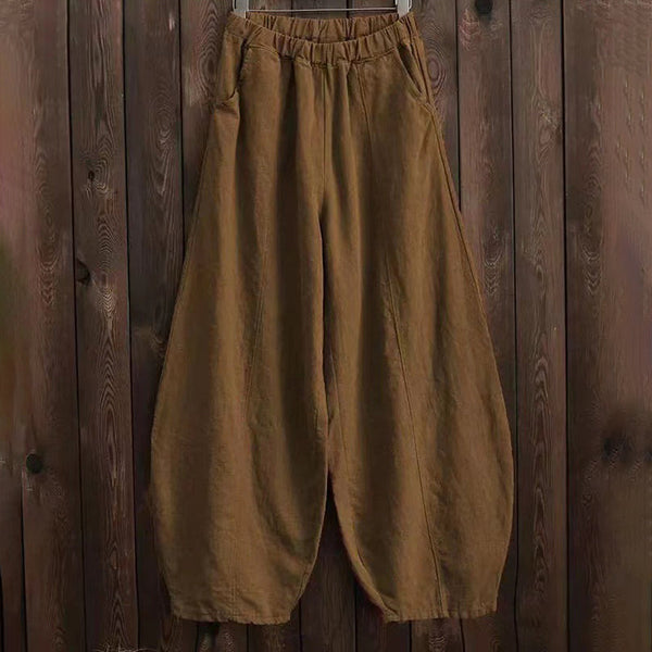 Bruine linnen harem broek voor dames, losse pasvorm, elastische tailleband, casual boho stijl, perfect voor zomer en lente mode.