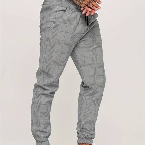Grijze geruite joggingbroek voor heren, comfortabele pasvorm, elastische tailleband, casual streetwear, modieuze herenkleding.