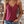 Vrouw in roze kanten top en denim shorts voor bakstenen muur, zomermode, casual outfit, trendy kleding, sieraden, boho stijl.