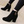 Zwarte suède enkellaarsjes met hoge hak en gouden sierdetail, stijlvolle damesmode, perfect voor herfst- en winteroutfits, trendy schoenen.