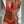 Vrouw in felrode bikini met witte blazer, modieuze strandkleding, zomeroutfit, trendy badmode, stijlvolle damesmode, minimalistische achtergrond.