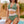 Vrouw in groene bikini met hoge taille en haltertop bij zwembad, zomermode, strandkleding, tropische achtergrond, trendy badmode.