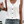 Vrouw draagt witte kanten top met knoopsluiting en denim shorts. Zomerse mode, casual outfit, trendy kledingstijl.