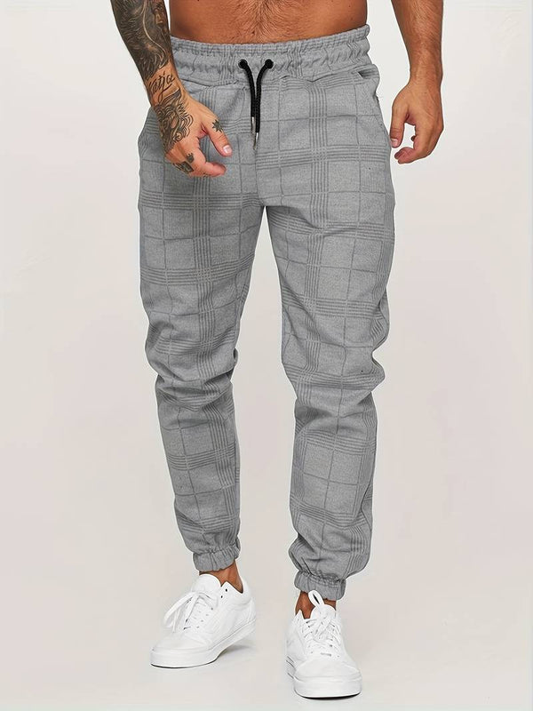 Grijze geruite joggingbroek voor heren, casual stijl, elastische tailleband, comfortabele pasvorm, ideaal voor sport en vrije tijd.