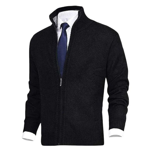 Zwarte herenvest met ritssluiting, gedragen over een witte overhemd en blauwe stropdas. Stijlvolle zakelijke kleding, ideaal voor kantoor.