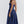 Vrouw in elegante, blauwe midi-jurk met spaghettibandjes, perfect voor zomer- of avondkleding. Stijlvolle mode voor dames, trendy en tijdloos design.