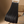 Zwarte geplooide rok op houten stoel, modieuze dameskleding, elegant design, perfect voor casual en formele gelegenheden, trendy modeaccessoire.