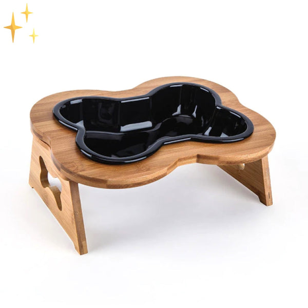 Houten hondenvoerbak met zwart botvormig ontwerp, verhoogd voor ergonomisch eten. Ideaal voor middelgrote honden. Duurzaam en stijlvol huisdieraccessoire.