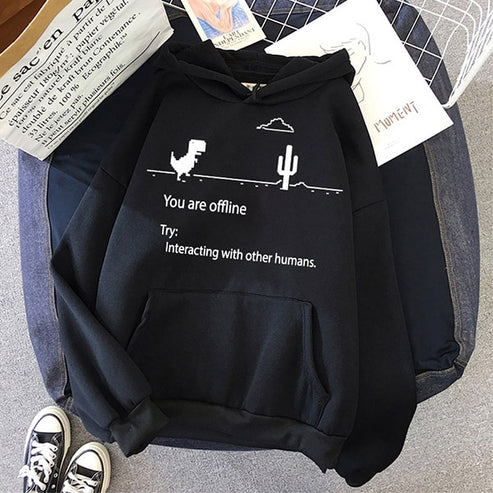 Zwarte hoodie met dinosaurus en cactus print, tekst "You are offline. Try: Interacting with other humans." Populaire casual mode, unisex kleding.