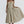 Vrouw in beige midi-jurk met spaghettibandjes en geplooide rok, elegante avondkleding, modetrend 2023, stijlvolle damesmode.