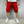 Man in rode cargoshorts met zakken, witte sneakers en wit T-shirt. Casual herenkleding, zomermode, streetwear stijl.