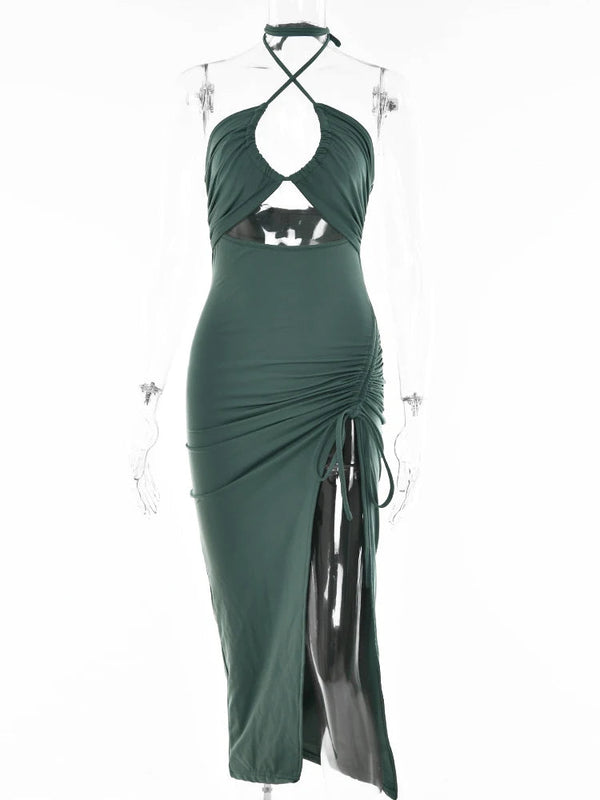 Donkergroene halterjurk met uitsnijding en ruches, asymmetrische zoom en hoge split. Perfect voor avondkleding en zomermode.