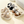 Vijf paar pluche kindersloffen met pompons in beige, zwart en grijs op een lichte achtergrond. Comfortabele winterpantoffels voor kinderen.