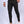 Man in zwarte slim-fit broek en witte sneakers, witte overhemd. Stijlvolle herenmode, casual outfit, moderne kledingstijl.