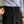 Man in gestreept overhemd en zwarte broek met hoge taille en dubbele knoopsluiting, stijlvolle zakelijke kleding, close-up van modeaccessoires.