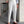 Stijlvolle witte herenbroek met hoge taille en dubbele knoopsluiting, gedragen met bruine loafers en een gestreept overhemd. Moderne herenmode.