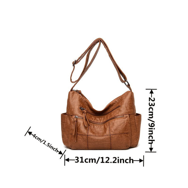 Bruine leren schoudertas met meerdere vakken, verstelbare riem en afmetingen: 31x23x14 cm. Ideaal voor dagelijks gebruik en modieuze uitstraling.
